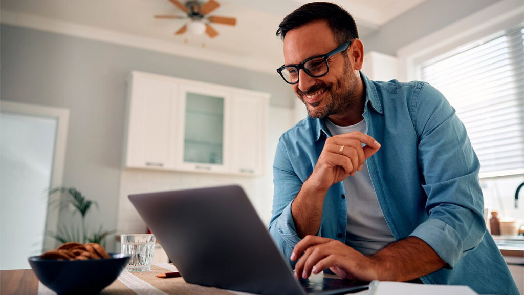 Man Using Laptop, Checking Emails