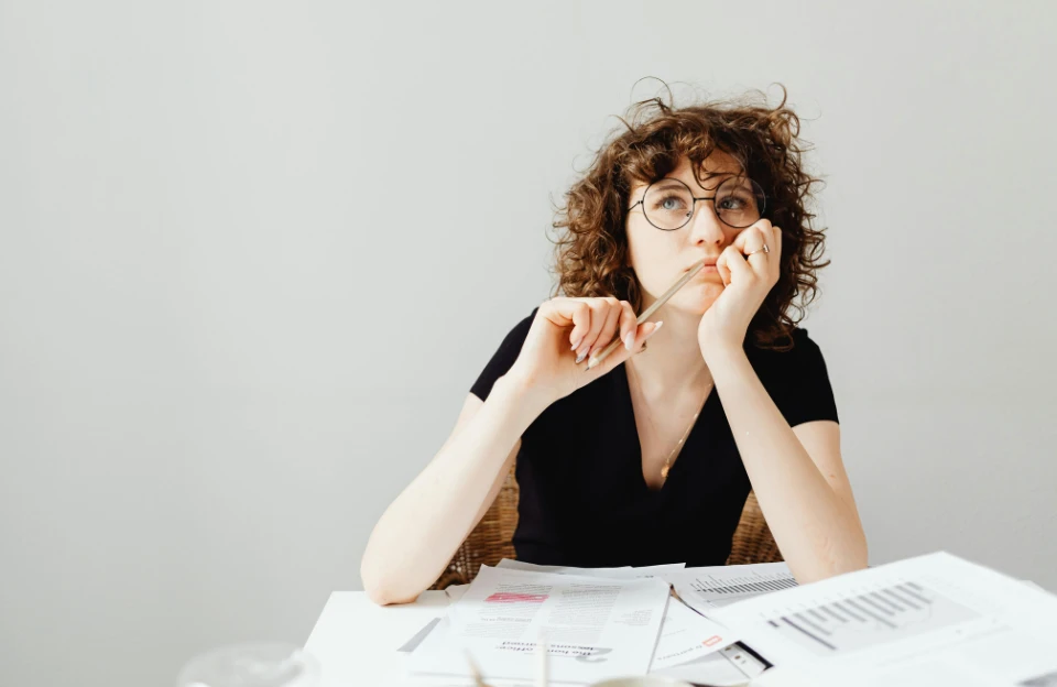 person sitting at desk struggling with procrastination