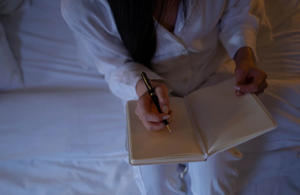girl writing notebook representing night-before preparation for a better morning