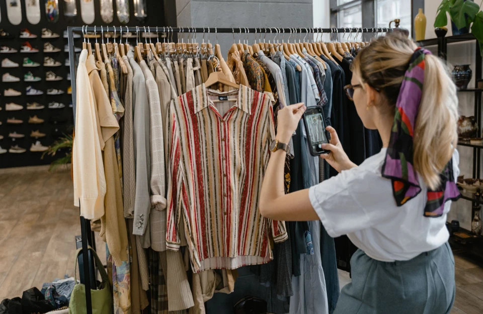 Reselling-clothes-on-app Person photographing clothes to list for sale on a resale app